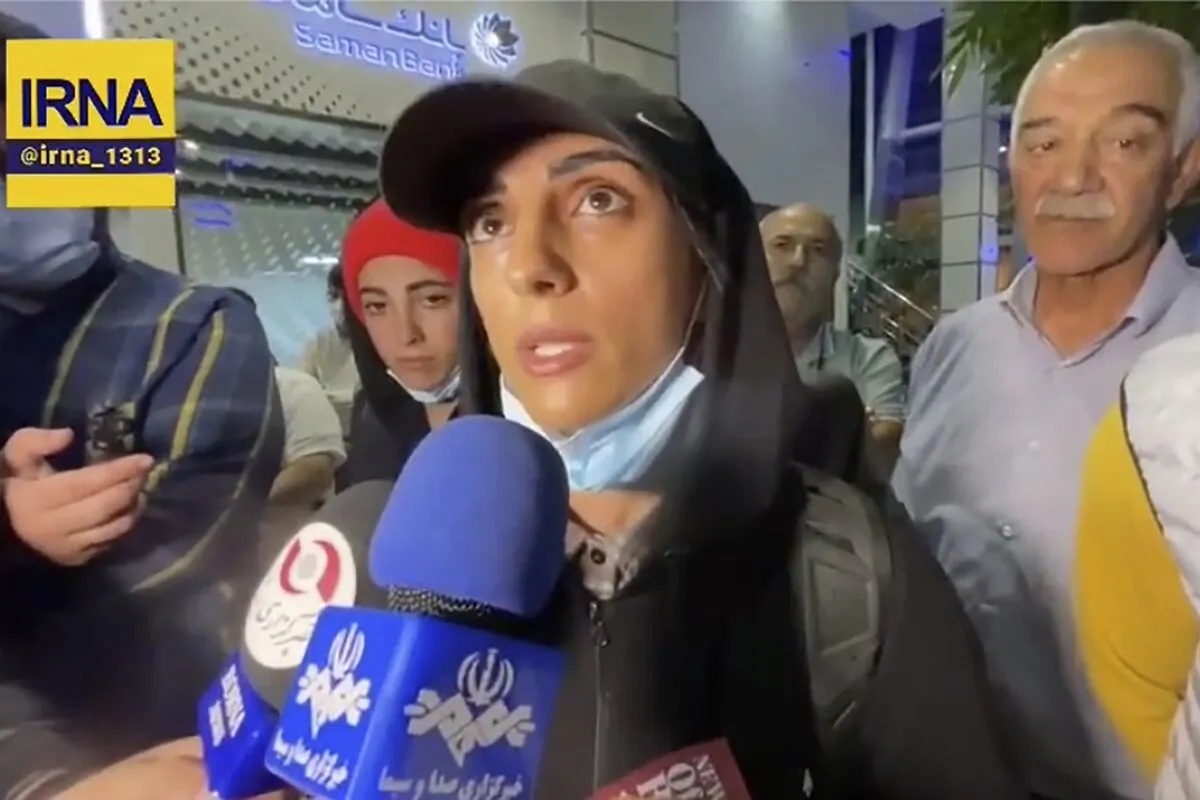 Iranian competitive climber Elnaz Rekabi speaks to journalists in Imam Khomeini International Airport in Tehran, Iran, on Oct. 19, 2022. (IRNA via AP)