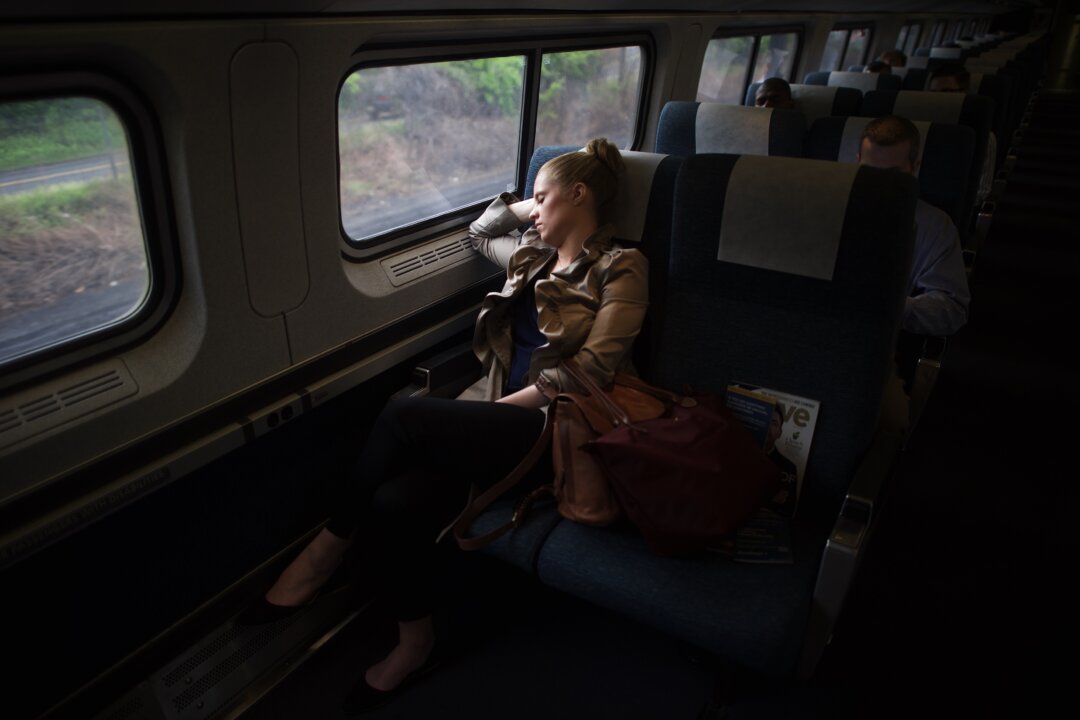 A passenger sleeps as she rides an Amtrak train from 30th Street Station in Philadelphia, Pennsylvania, on May 18, 2015. (Mark Makela/Getty Images)