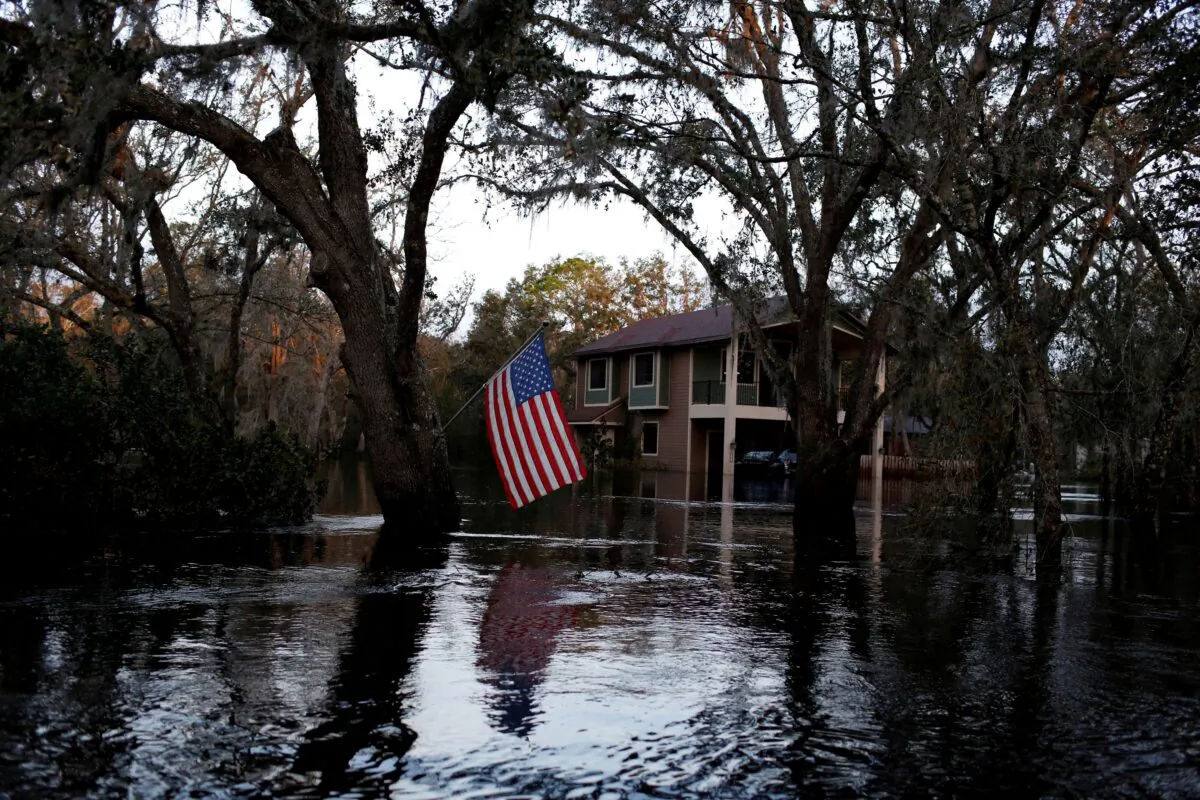 A U.S. flag in a flooded rural area after Hurricane Ian caused widespread destruction in Arcadia, Fla., on Oct. 4, 2022. (Marco Bello/Reuters)