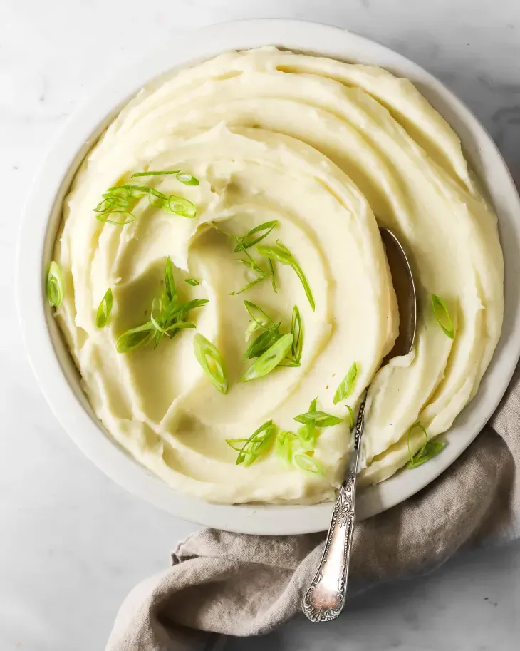 Traditional mashed potatoes get an extra dose of luxe flavor from sour cream. (Maria Do/TNS)