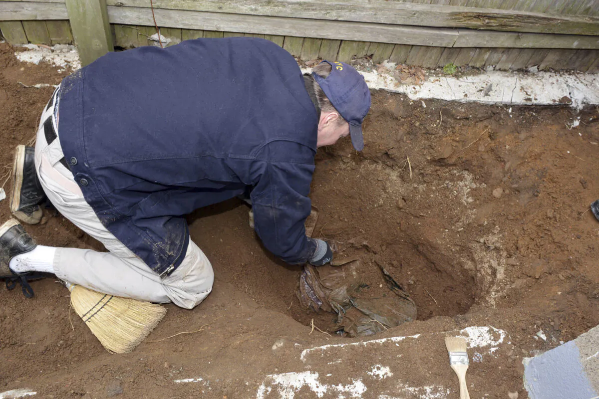 Anthropologist Dr. Bradley Adams, of the Office of the Chief Medical Examiner, examines buried human remains of World War I veteran George Seitz, on March 12, 2019. (Office of the Chief Medical Examiner via AP)