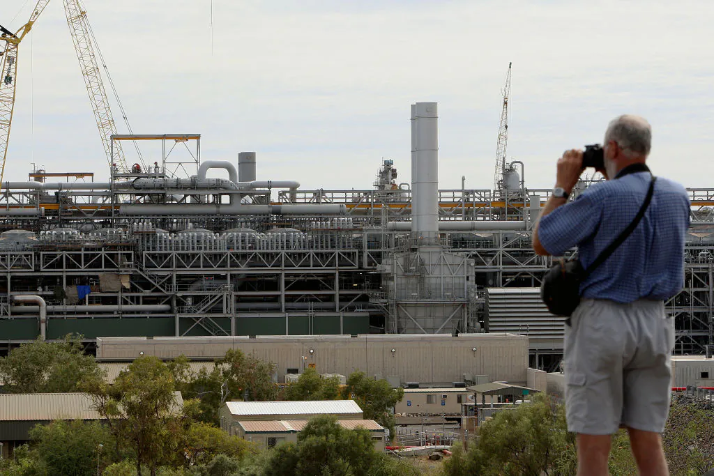 A tourist photographs the gas production area at the Woodside operated North West Shelf Gas Venture in the north of Western Australia, on June 16, 2008. (Greg Wood/AFP via Getty Images)