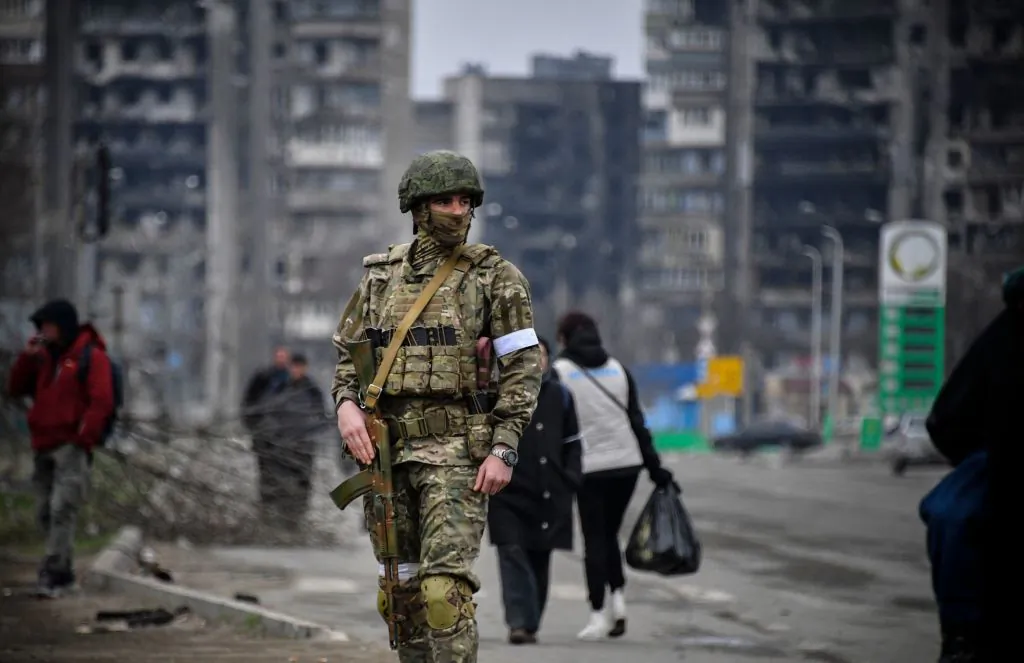 A Russian soldier patrols in a street of Mariupol, Ukraine, on April 12, 2022. (Alexander Nemenov/AFP via Getty Images)