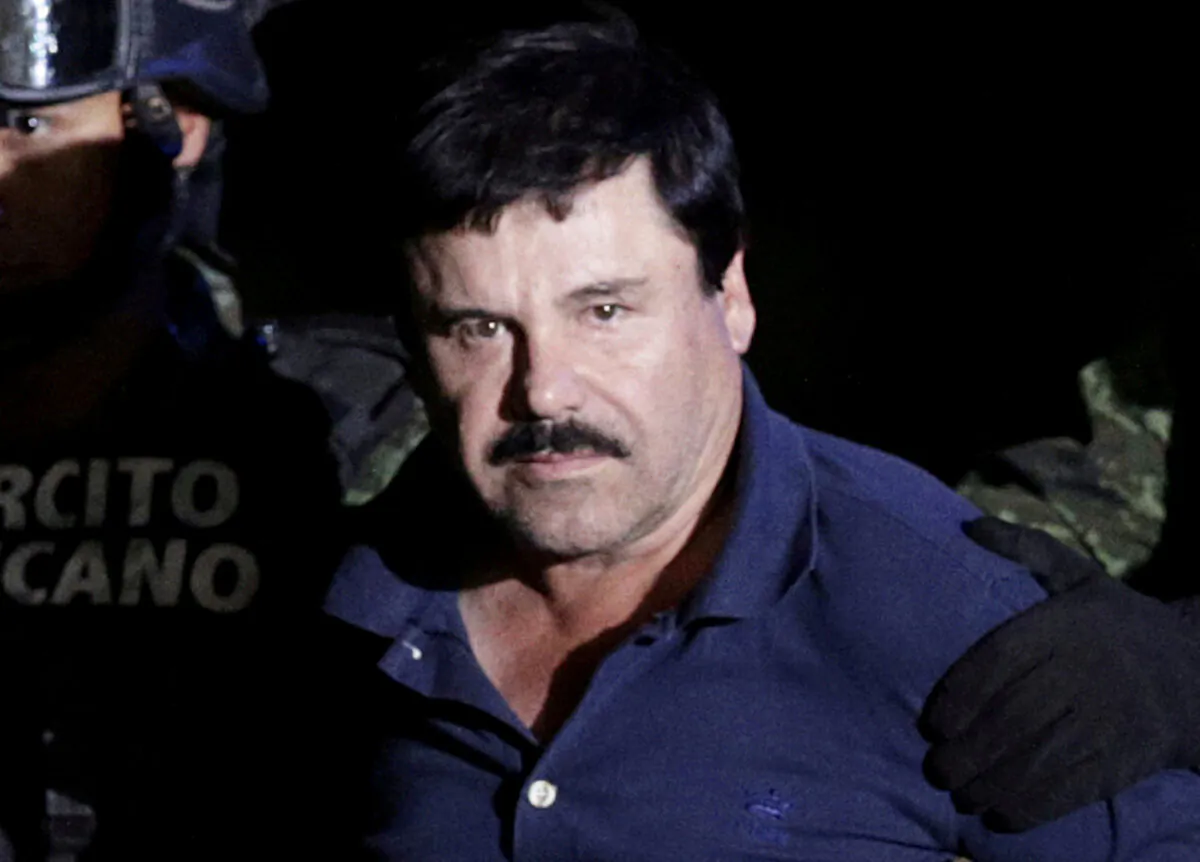 Recaptured drug lord Joaquin "El Chapo" Guzman is escorted by soldiers at the hangar belonging to the office of the Attorney General in Mexico City on Jan. 8, 2016. (Henry Romero/Reuters)