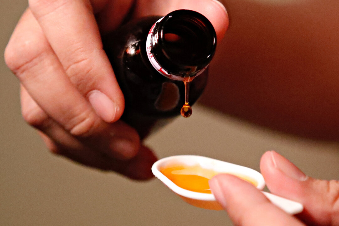 A cough medication is poured in this picture illustration taken on Oct. 19, 2022. (Ajeng Dinar Ulfiana/Reuters)