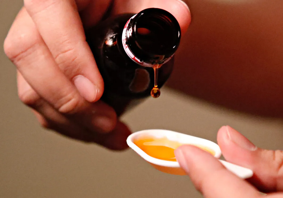 A cough medication is poured in this picture illustration taken on Oct. 19, 2022. (Ajeng Dinar Ulfiana/Reuters)