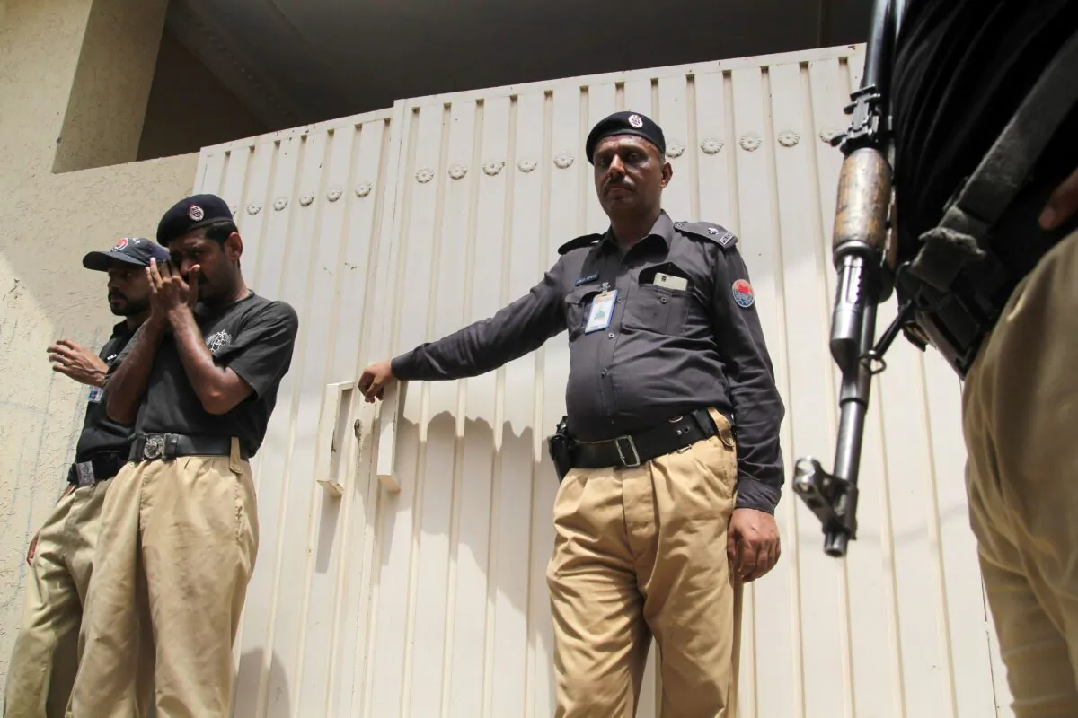 Pakistani policemen stand guard outside a property in Multan on July 16, 2016. (SHAHID SAEED MIRZA/AFP via Getty Images)