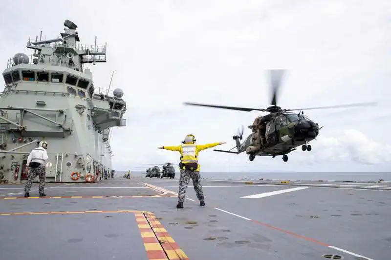 A supplied image obtained Tuesday, February 2, 2021 of An Australian Army MRH-90 Taipan multirole helicopter launches from the flight deck of HMAS Adelaide. On Thursday 24 December 20, over 600 Australian Defence Force (ADF) personnel deployed on HMAS Adelaide for Fiji to assist with the Fiji Government’s disaster relief in response to Tropical Cyclone Yasa. (AAP Image/Australian Defence) 