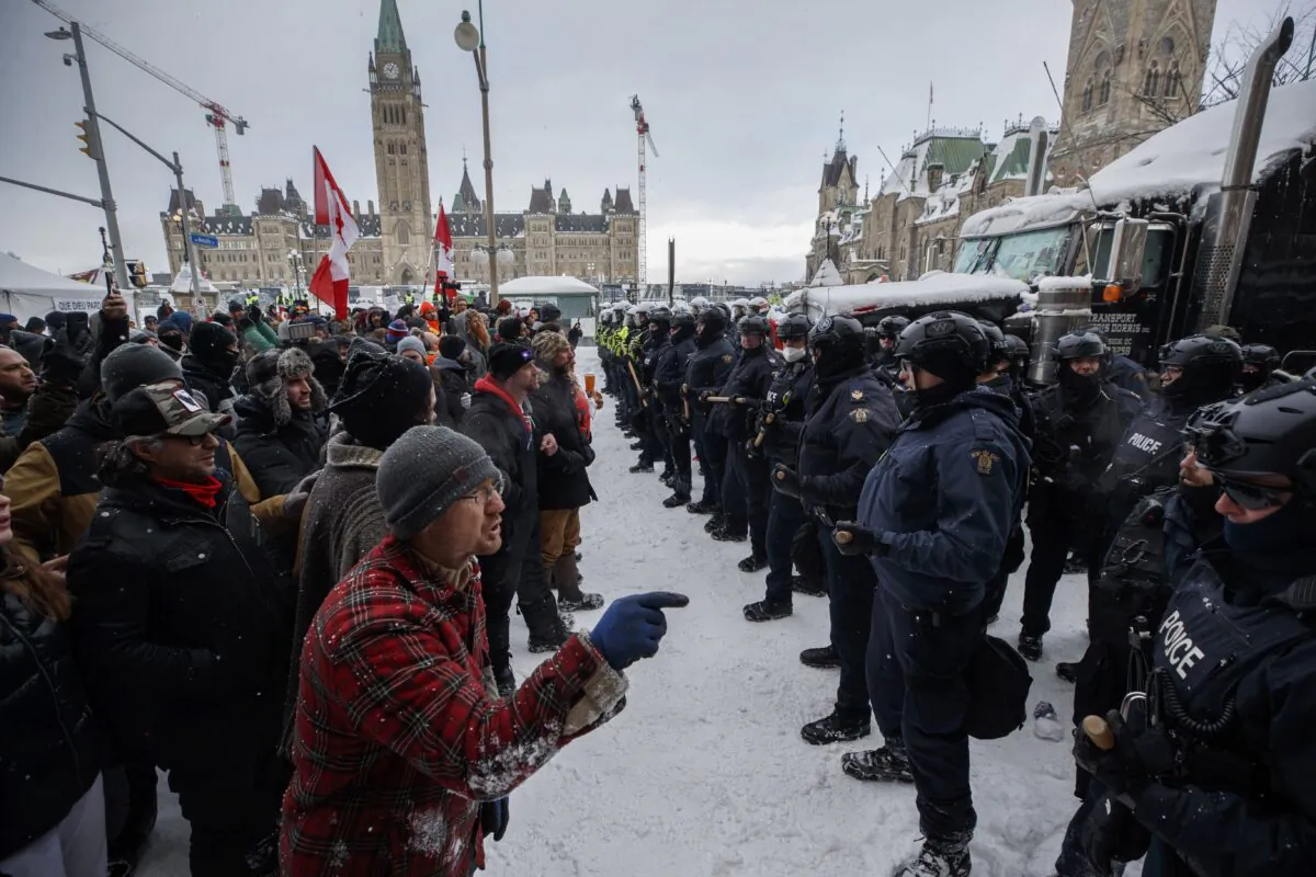 Police move in to clear downtown Ottawa near Parliament Hill of protesters after weeks of demonstrations on Feb. 19, 2022. (The Canadian Press/Cole Burston)
