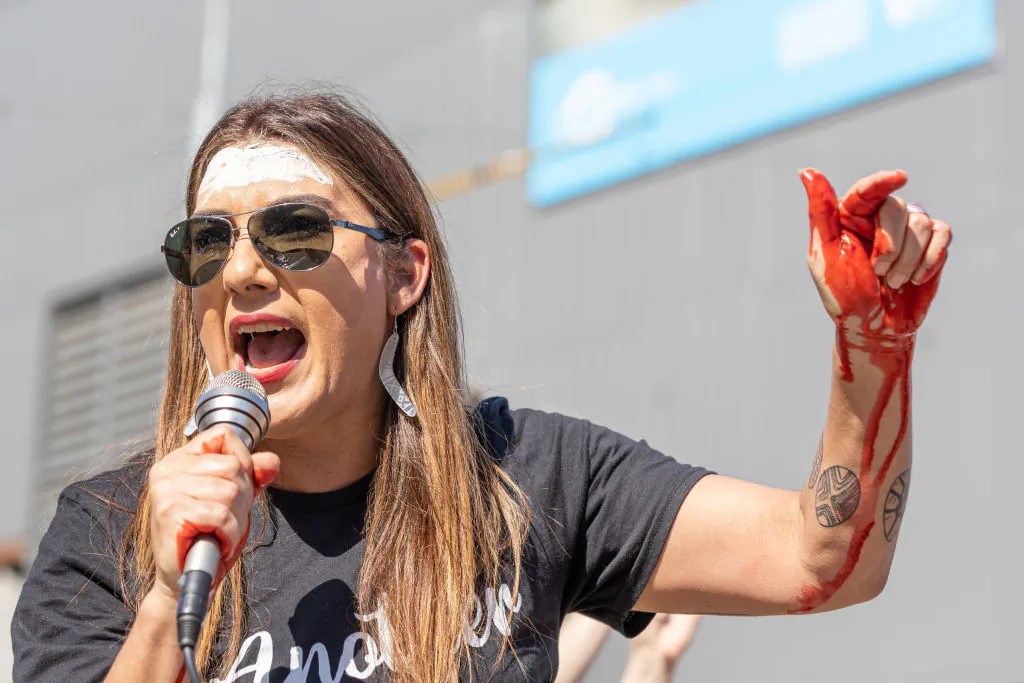 Ex-Deputy Leader of the Greens in the Senate Lidia Thorpe speaks to the crowd with mock blood on her hands on September 22, 2022 in Melbourne, Australia. Indigenous groups have held "Abolish the Monarchy" rallies around Australia on Thursday to highlight the impact of British colonisation in Australia. Thursday 22 September was declared a one-off public holiday as a National Day of Mourning for Australia following Queen Elizabeth II's death. (Photo by Asanka Ratnayake/Getty Images)