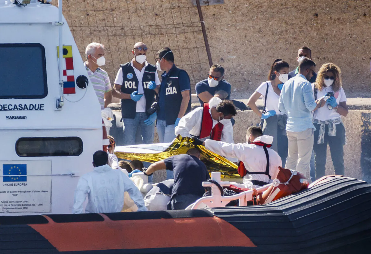 Bodies are disembarked on the tiny Sicilian island of Lampedusa, Italy, on Oct. 21, 2022. (David Lohmueller/AP Photo)