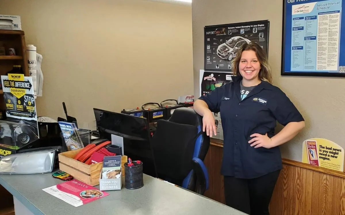 Tiffany Toscano of Benton County, Minnesota, at her full-time job as a service adviser at a small, independent automotive repair shop. The single mother also works as a school janitor and has a small commercial and residential cleaning business. (Courtesy of Tiffany Toscano)