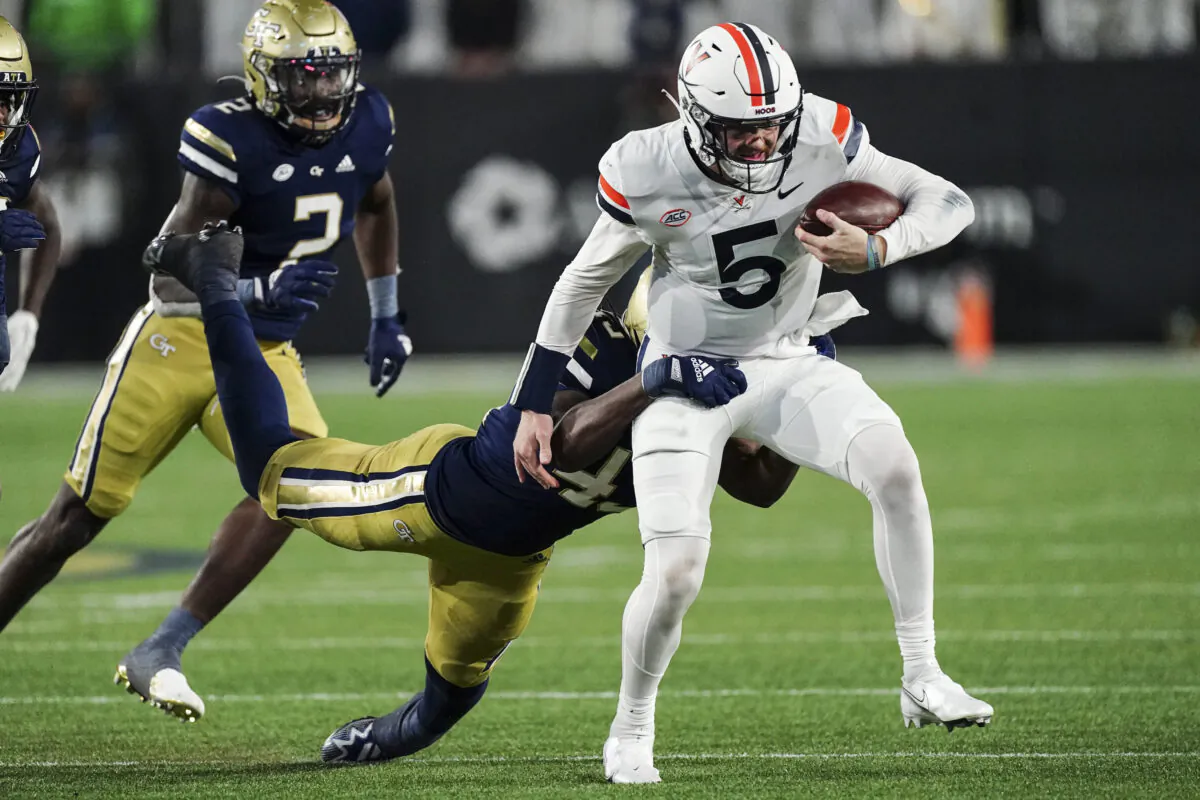 Virginia quarterback Brennan Armstrong (5) is brought down by Georgia Tech defensive lineman Noah Collins (43) during the first half of an NCAA college football game in Atlanta, on Oct. 20, 2022. (John Bazemore/AP Photo)