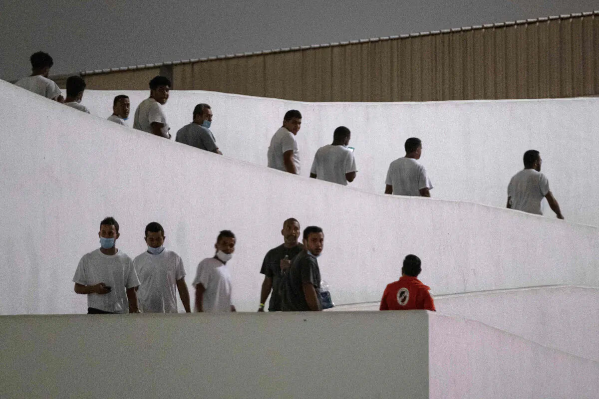 Venezuelan migrants walk after been deported by U.S. authorities at El Chaparral crossing port of entry in Tijuana, Baja California state, Mexico, on Oct. 13, 2022. Mexico agreed to accept deported Venezuela migrants from the United States, authorities announced Oct. 12. (Guillermo Arias/AFP/Getty Images)