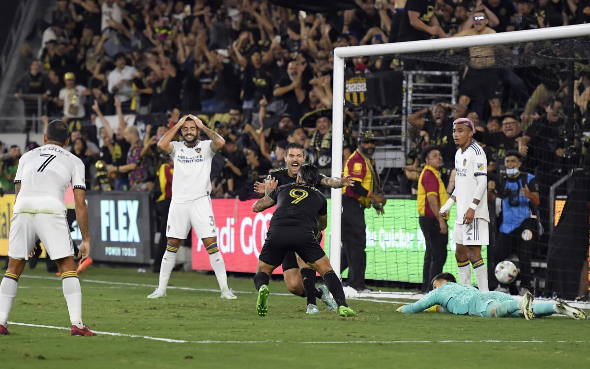 Cristian "Chicho" Arango (9) of Los Angeles FC celebrates with Ryan Hollingshead (24) after scoring the winning goal against Los Angeles Galaxy during the second half of the Western Conference Semifinals of 2022 MLS Cup playoffs at Banc of California Stadium in Los Angeles, on Oct. 20, 2022. (Kevork Djansezian/Getty Images)