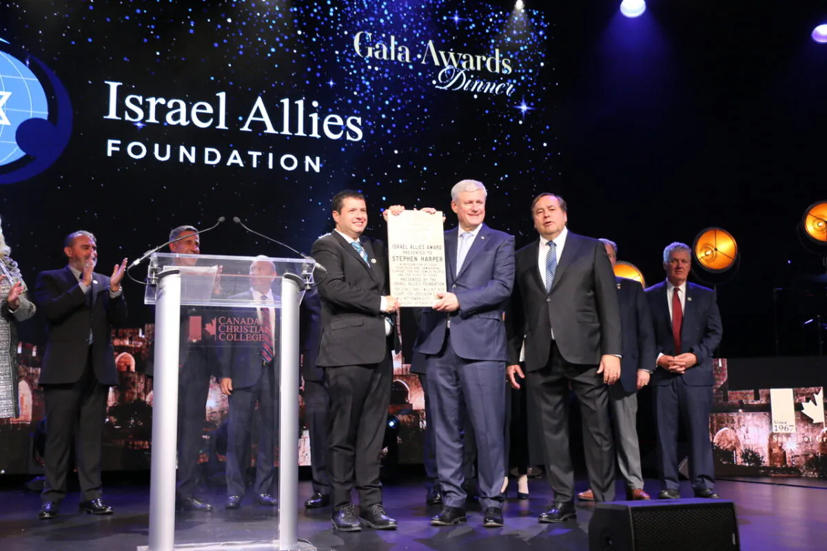 Former Prime Minister Stephen Harper is presented with an award for his support of Israel at a gala event co-hosted by the Israel Allies Foundation at the Canada Christian College on Oct. 20, 2022. (Andrew Chen/The Epoch Times)