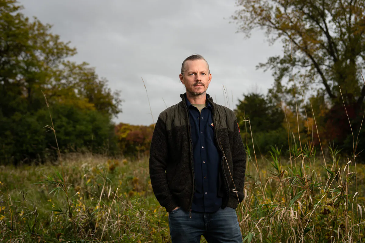 Michael Nichols stands in the backyard of his home in King Ferry, N.Y., on Oct. 13, 2022. (Samira Bouaou/The Epoch Times)