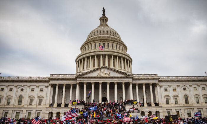 A large group of protesters stand on the East steps of the Capitol Building after breaching its grounds in Washington, D.C., on Jan. 6, 2021. (Jon Cherry/Getty Images)