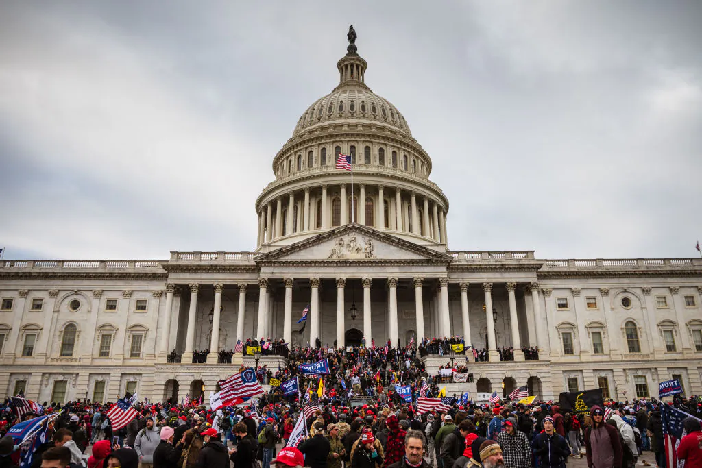 A large group of protesters stand on the East steps of the U.S. Capitol after breaching its grounds in Washington on Jan. 6, 2021. (Jon Cherry/Getty Images)