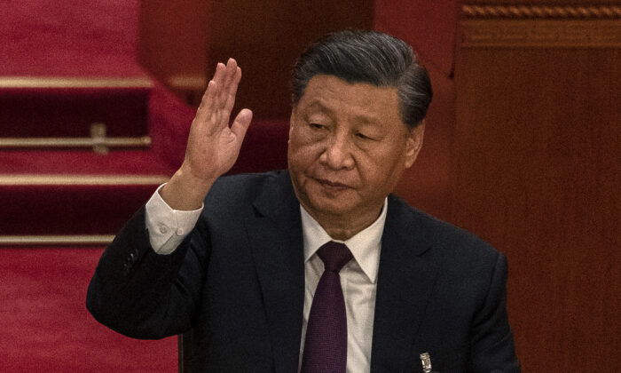 Chinese Leader Xi Jinping raises his hand as he votes during the closing session of the 20th National Congress of the Chinese Communist Party at The Great Hall of People in Beijing on Oct. 22, 2022. (Kevin Frayer/Getty Images)