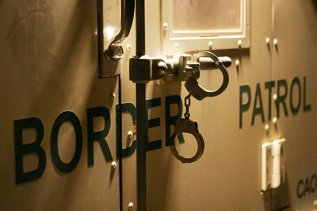 Handcuffs secure the back door of a U.S. Customs and Border Protection border patrol vehicle. (David McNew/Getty Images)