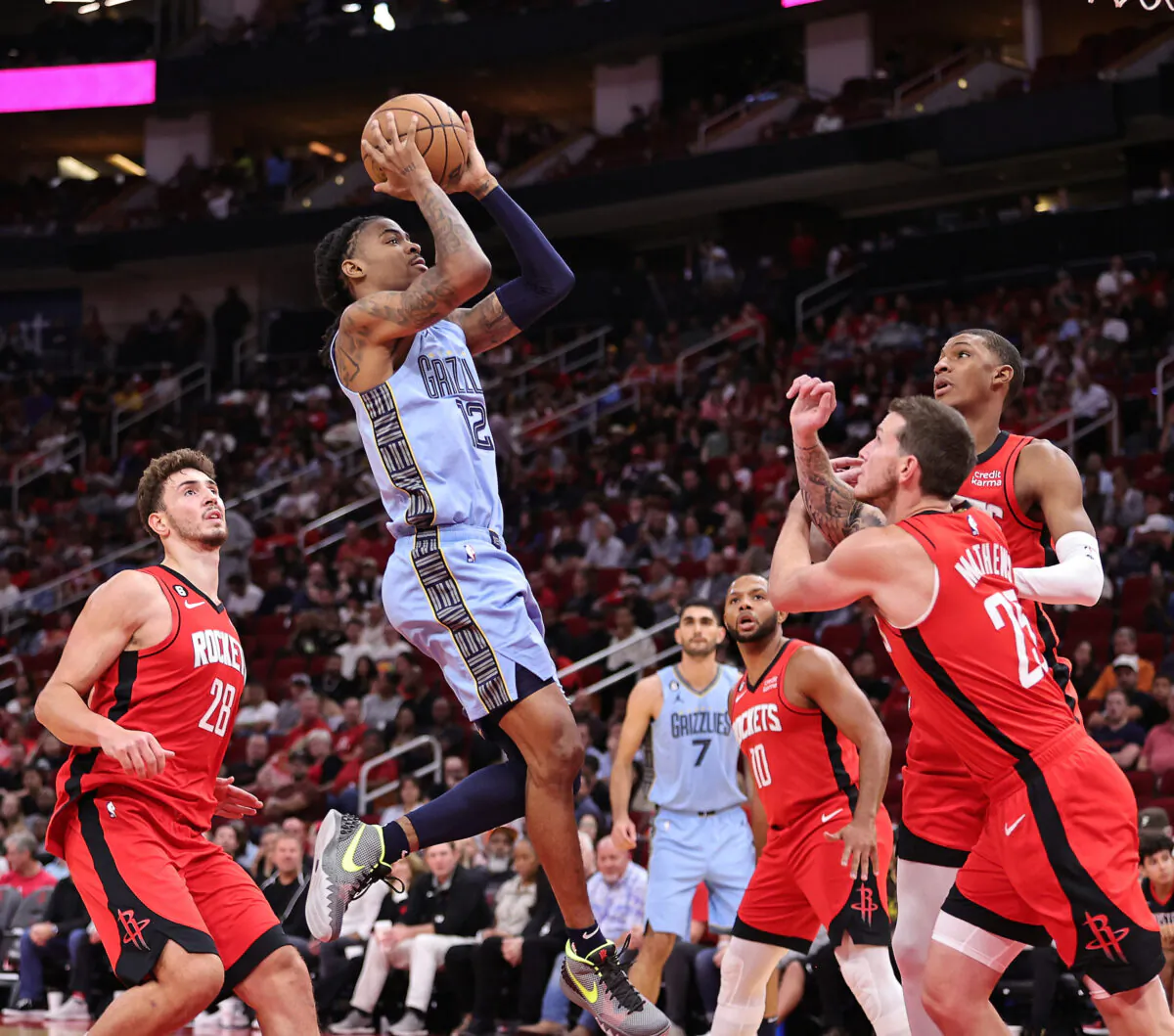 Ja Morant (12) of the Memphis Grizzlies drives past Alperen Sengun (28) of the Houston Rockets during the second quarter at Toyota Center in Houston, on Oct. 21, 2022. (Bob Levey/Getty Images)
