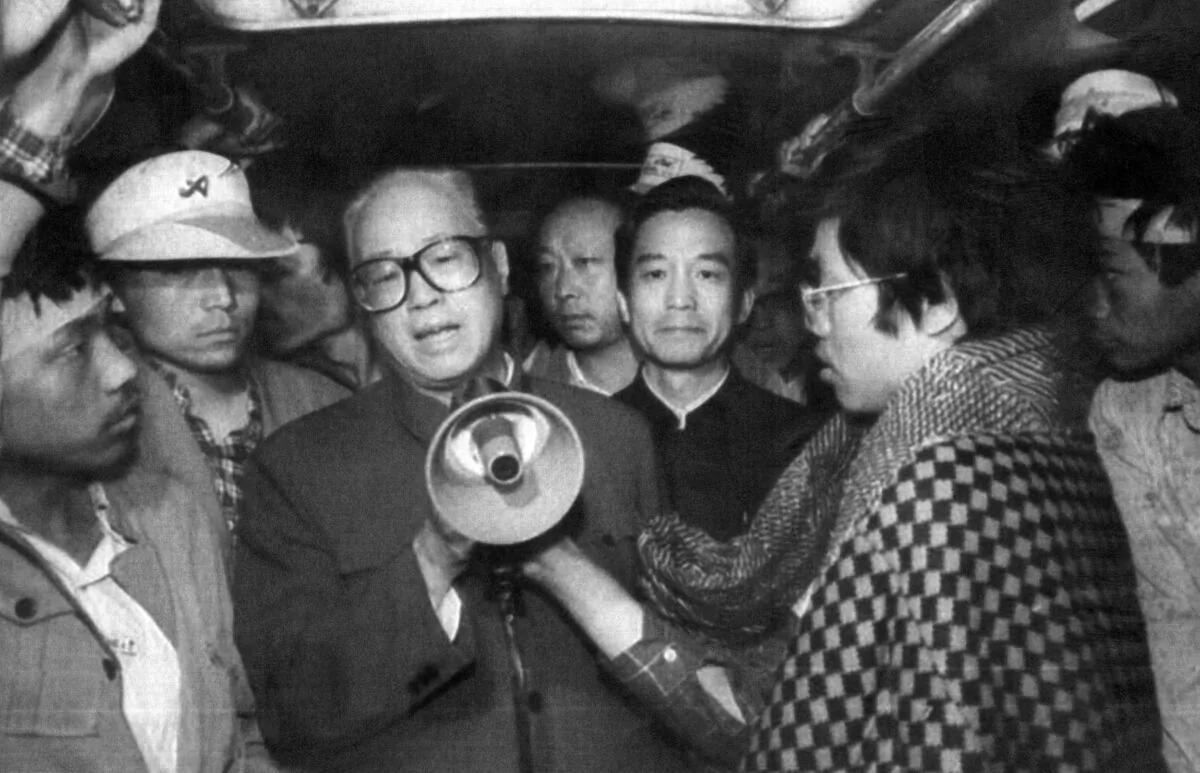 Chinese Communist Party (CCP) General Secretary Zhao Ziyang (C) uses a megaphone to address the student hunger strikers at dawn in one of the buses at Tiananmen Square in Beijing on May 19, 1989. (Xinhua/AFP via Getty Images)