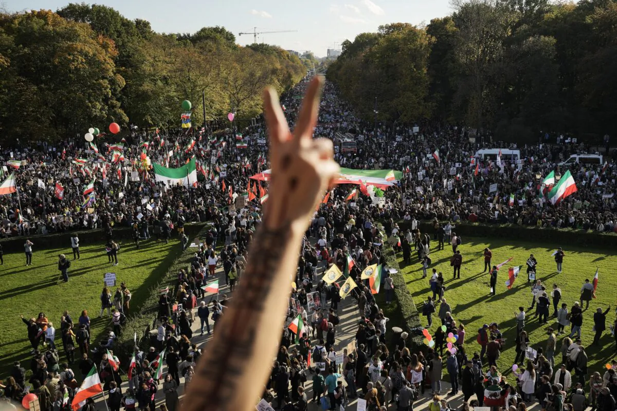 A man gestures as people attend a protest against the Iranian regime, in Berlin on Oct. 22, 2022. (Markus Schreiber/AP Photo)