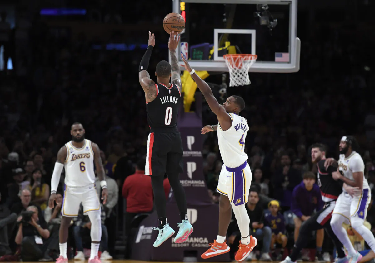 Damian Lillard (0) of the Portland Trail Blazers scores a three-point basket in the closing seconds of the game against Lonnie Walker IV (4) of the Los Angeles Lakers during the second half at Crypto.com Arena in Los Angeles, on Oct. 23, 2022. (Kevork Djansezian/Getty Images)