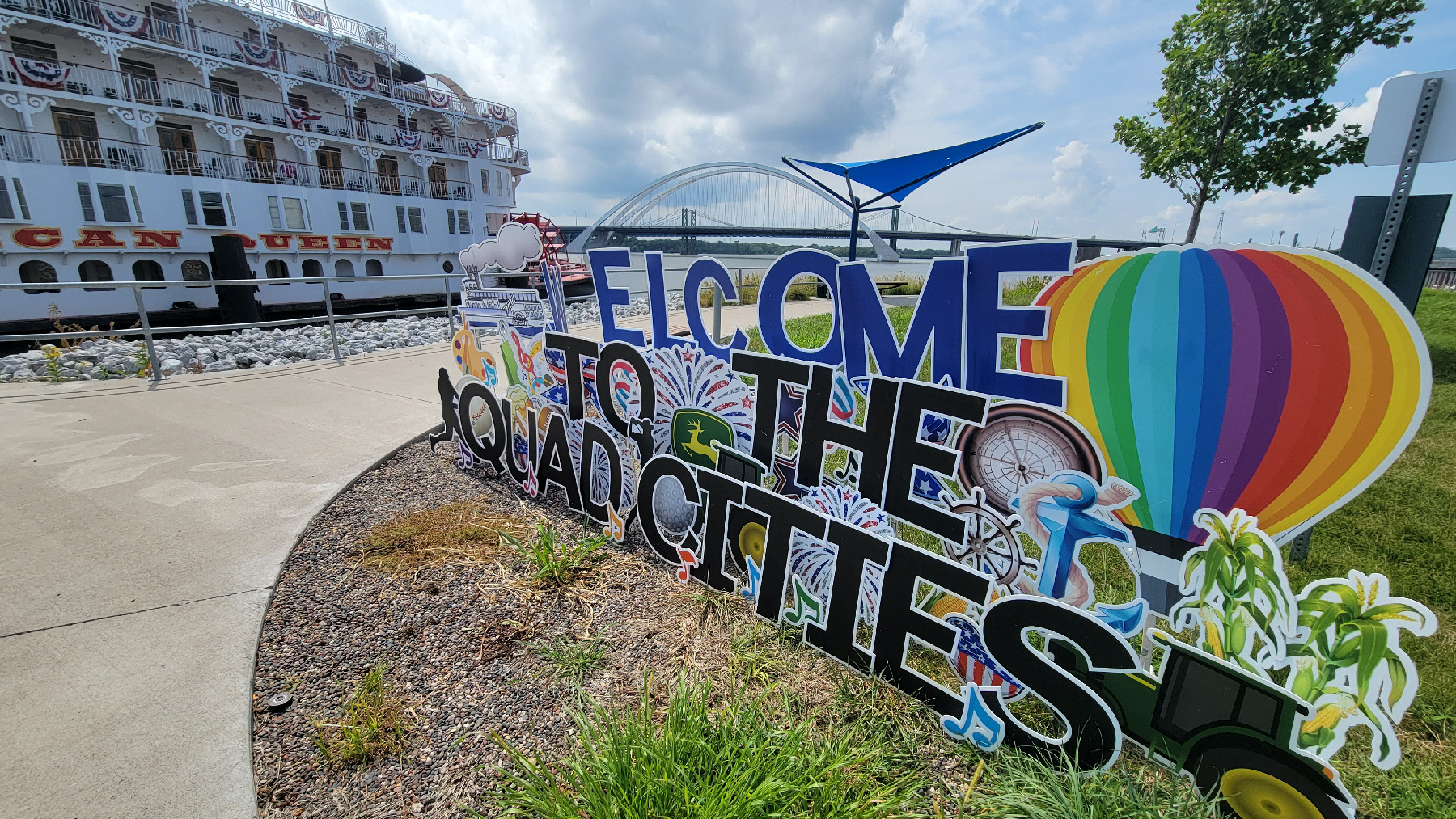 A colorful sign welcomes visitors to the Quad Cities of Rock Island and Moline, Illinois, and Davenport and Bettendorf, Iowa.