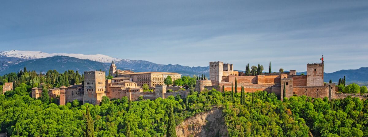 The majestic Alhambra palace, on top of the hill al-Sabika, overlooks the city of Granada. In Arabic, “Alhambra” means “ the red”, and the name is thought to be derived from the reddish color of the outer walls, built out of tapia (rammed earth). The complex has 26 acres, one mile of walls, four main gates, and 30 towers, creating a city within a city. (Botond Horvath/Shutterstock)