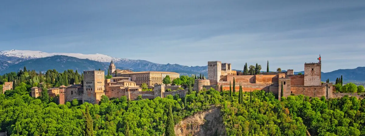 The majestic Alhambra palace, on top of the hill al-Sabika, overlooks the city of Granada. In Arabic, “Alhambra” means “ the red”, and the name is thought to be derived from the reddish color of the outer walls, built out of tapia (rammed earth). The complex has 26 acres, one mile of walls, four main gates, and 30 towers, creating a city within a city. (Botond Horvath/Shutterstock)