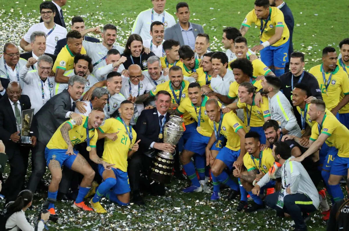 Brazil's President Jair Bolsonaro and Brazil players celebrate winning the Copa America with the trophy at Maracana Stadium in Rio de Janeiro on July 7, 2019. (Sergio Moraes/Reuters)