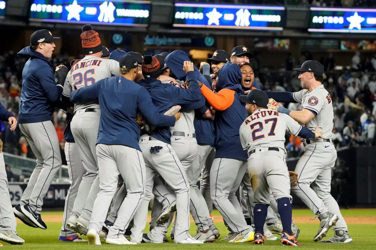 The Houston Astros celebrate after defeating the New York Yankees 6–5 to win Game 4 and the American League Championship baseball series in New York on Oct. 24, 2022. (John Minchillo/AP Photo)