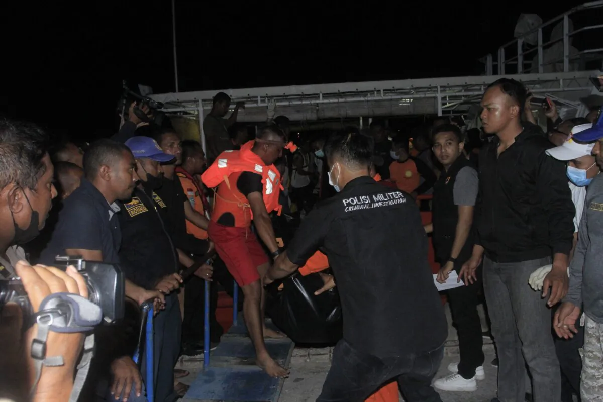 Indonesian search and rescue team personnel carry a victim after a boat caught fire in Kupang, East Nusa Tenggara Province, Indonesia, on Oct. 24, 2022. (Olivier/AFP via Getty Images)