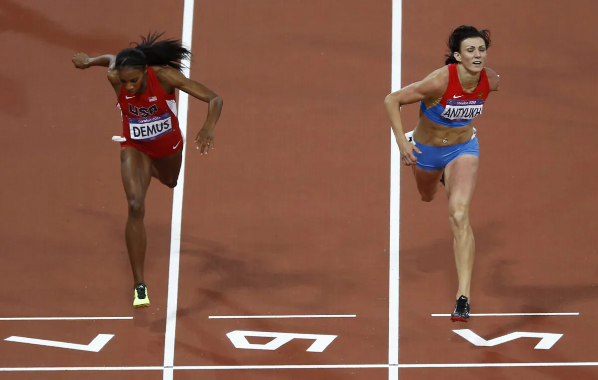 Russia's Natalya Antyukh (R) powers ahead of United States' Lashinda Demus to win gold in the women's 400-meter hurdles final during the athletics in the Olympic Stadium at the 2012 Summer Olympics in London on Aug. 8, 2012. (Daniel Ochoa De Olza/AP Photo)
