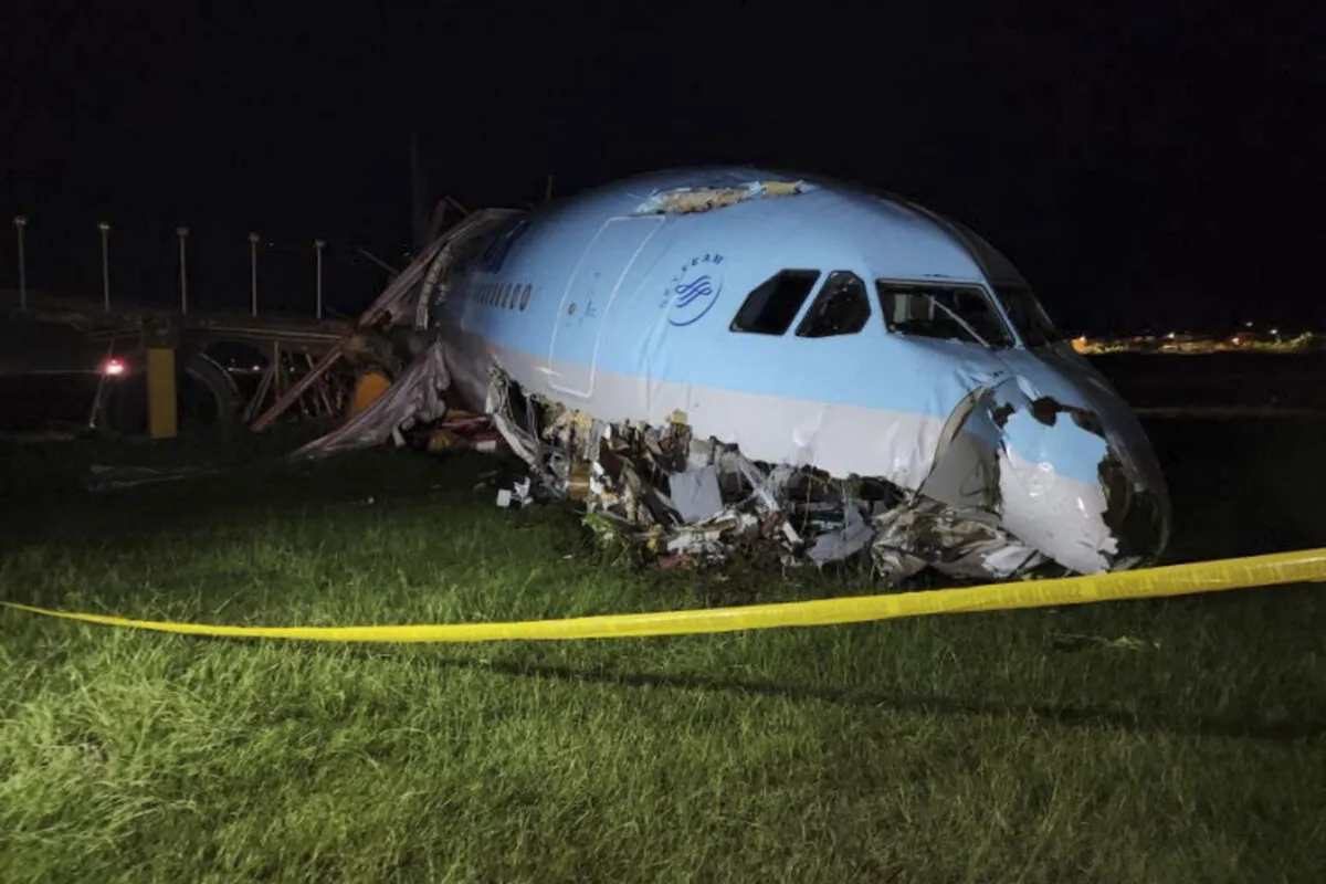 In this handout photo provided by the Civil Aviation Authority of the Philippines, a damaged portion of the Korean Air Lines Co. plane lies after it overshot the runway at the Mactan Cebu International Airport in Cebu, central Philippines, on Monday, Oct. 24, 2022. (Civil Aviation Authority of the Philippines via AP)