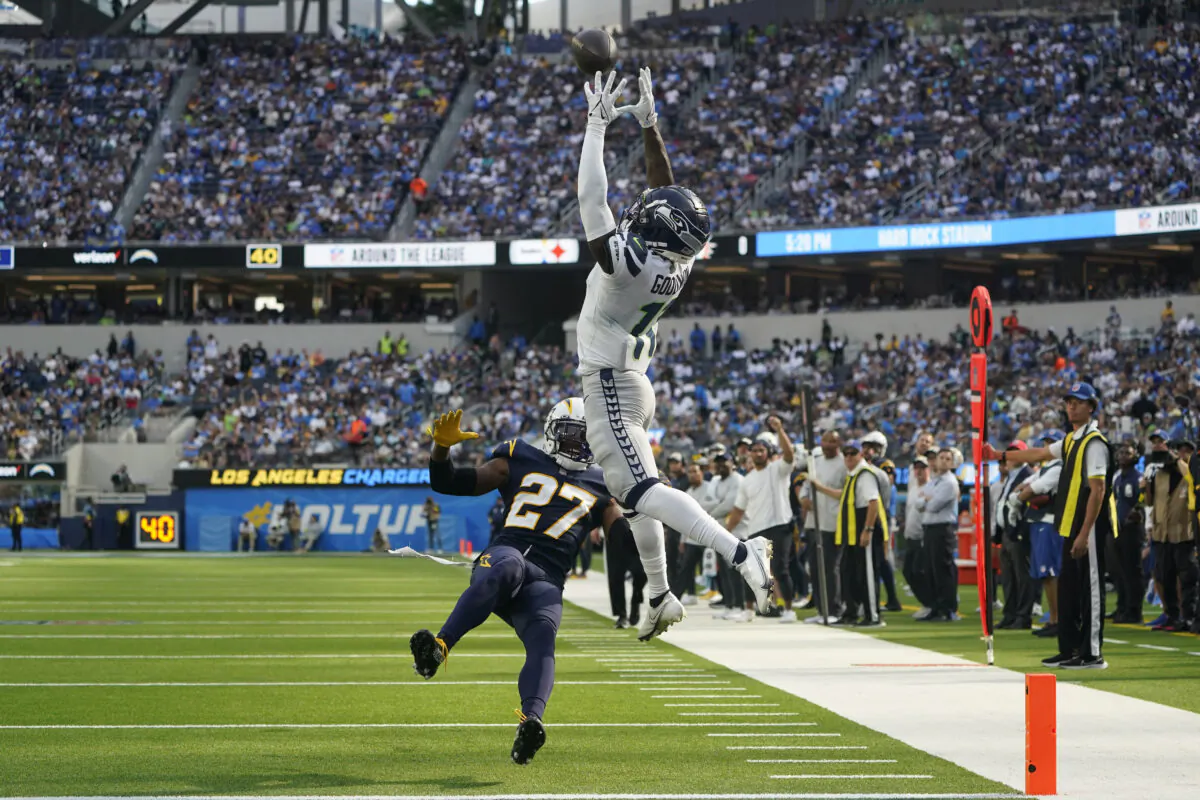 Seattle Seahawks wide receiver Marquise Goodwin (11) catches a pass for a touchdown during the first half of an NFL football game against the Los Angeles Chargers in Inglewood, Calif., on Oct. 23, 2022. (Marcio Jose Sanchez/AP Photo)