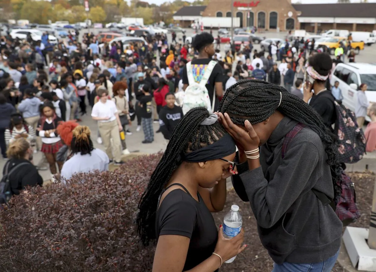 Students stand in a parking lot near the Central Visual & Performing Arts High School after a reported shooting at the school in St. Louis on Oct. 24, 2022. (David Carson/St. Louis Post-Dispatch via AP)