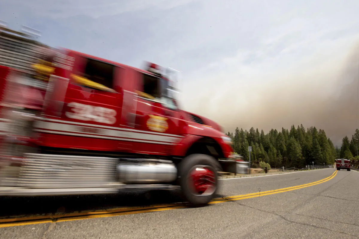 Fire department rescuers pulled a woman from a septic tank in Fontana. (AP Photo/Ethan Swope)