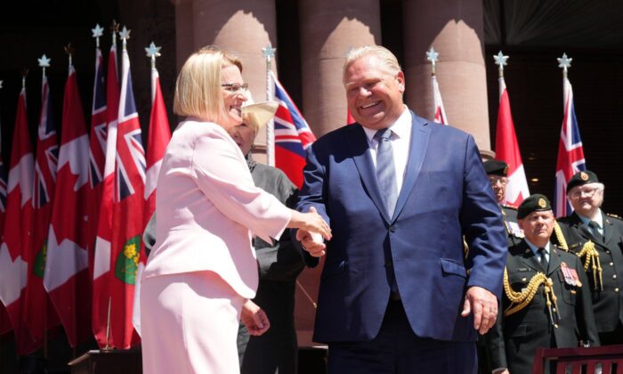 Deputy Prime Minister and Minister of Health Sylvia Jones shakes hands with Prime Minister Doug Ford during the swearing-in ceremony in Queens Park, Toronto, June 24, 2022.  (The Canadian Press/Nathan Denette)