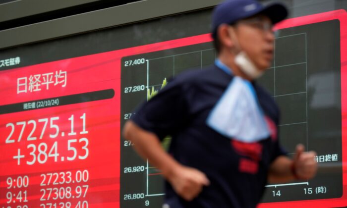 2022 年 10 月 24 日，在日本东京的一家证券公司，一名男子在显示日本日经 225 指数的显示器前慢跑。（Hiro Komae/美联社照片）