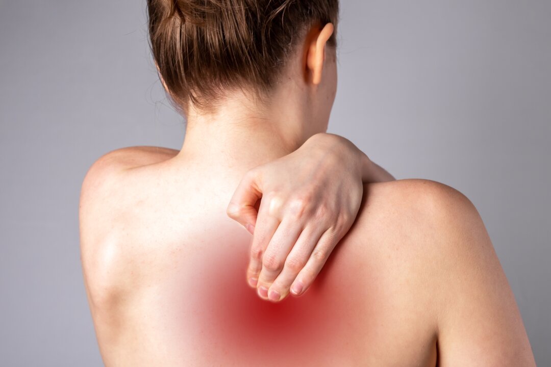 A tingling sensation in the shoulder area is the most common symptom of a pinched nerve, and it is very often accompanied by some numbness. (valiantsin suprunovich/Shutterstock)