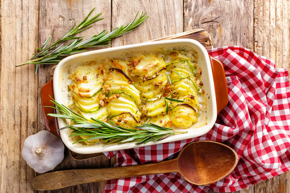 A potato gratin is a cheese lover's gift, with ultrathin layers of sliced potatoes blanketed in oozing cheese, cream, and, yes, more cheese. (Sea Wave/Shutterstock)