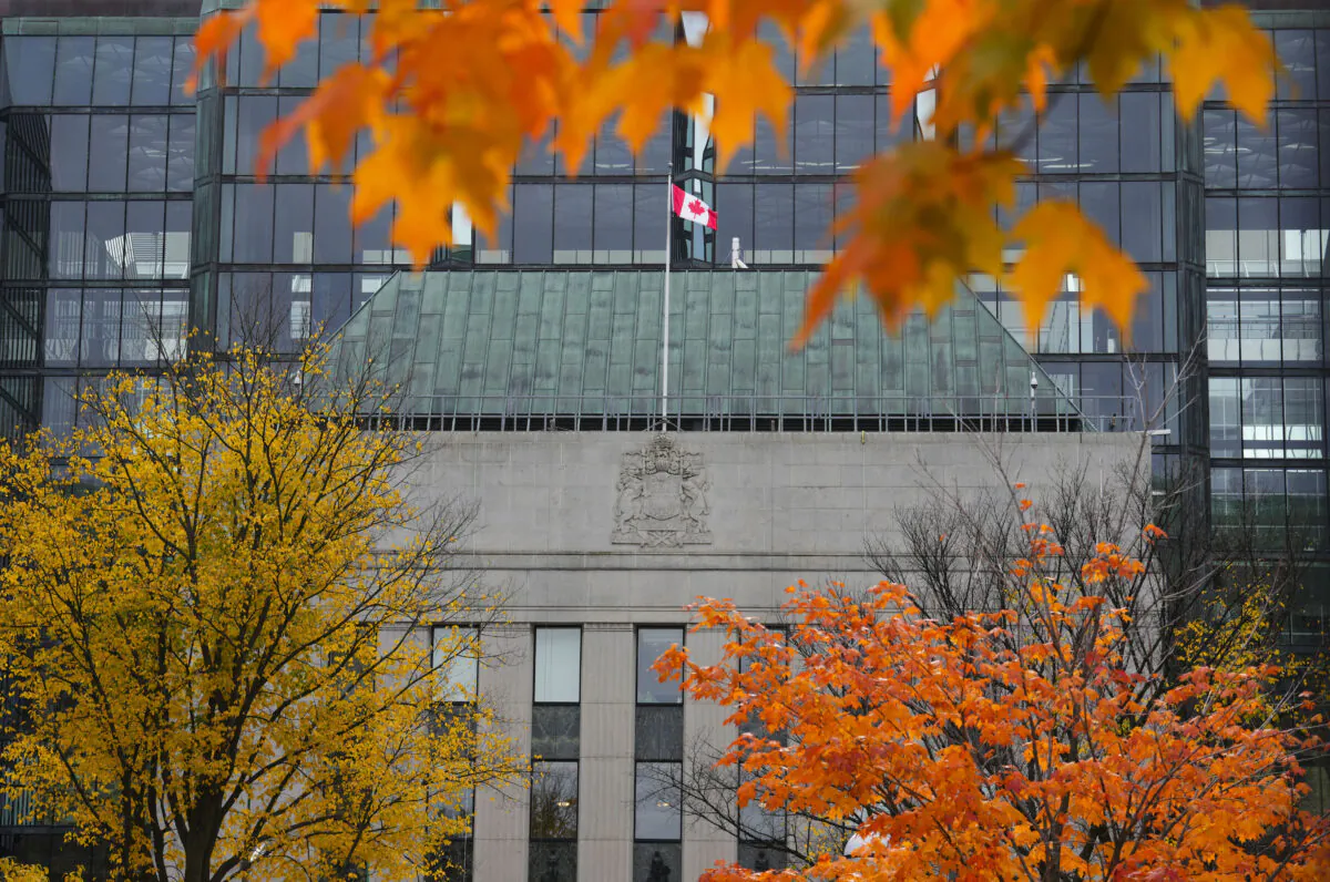 The Bank of Canada is framed through fall foliage as colours peak in Ottawa, on Oct. 19, 2022. (Sean Kilpatrick/The Canadian Press)