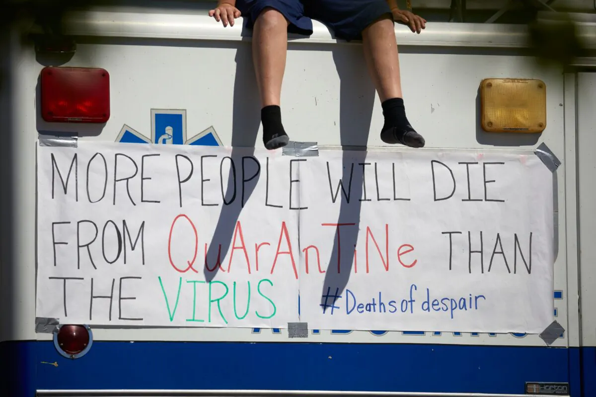 Protesters from a grassroots organization called REOPEN NC protests the North Carolina coronavirus lockdown at a parking lot adjacent to the N.C. State Legislature in Raleigh, N.C., on April 14, 2020. (Logan Cyrus/AFP via Getty Images)