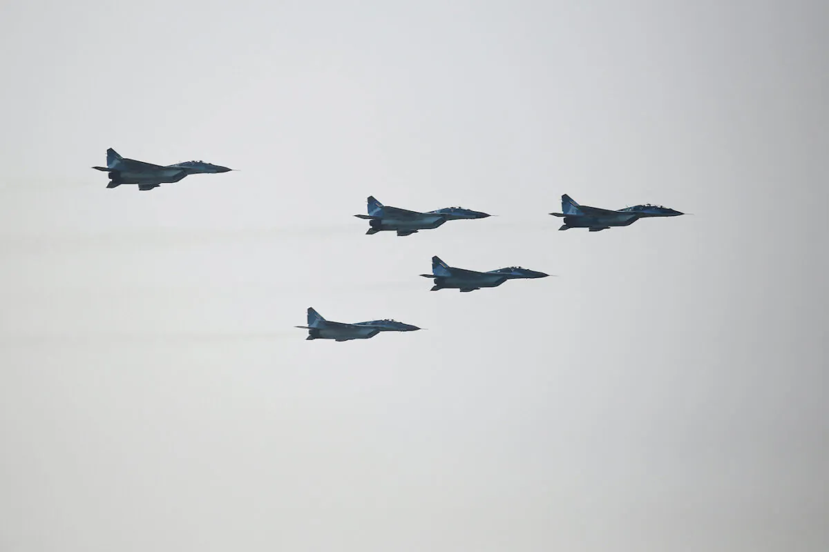 Burmese junta fighter jets flyover the capital Naypyidaw on March 27, 2022. (STR/AFP via Getty Images)
