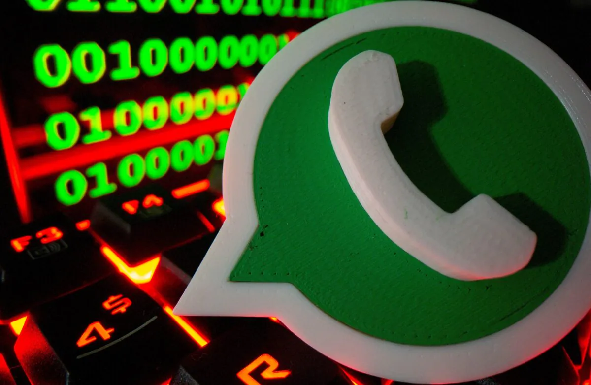 A 3D printed Whatsapp logo on a keyboard in front of binary code in this illustration taken on Sept. 24, 2021. (Dado Ruvic/Illustration/Reuters)