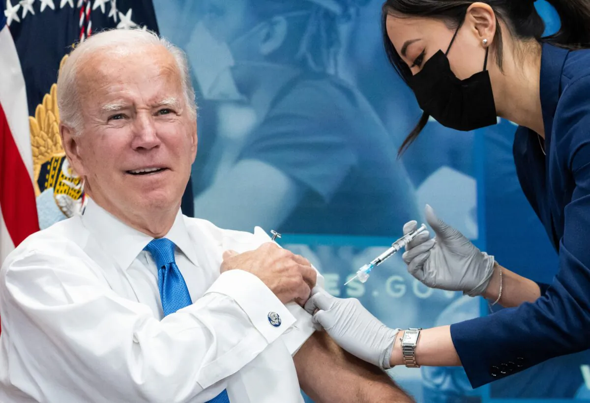 President Joe Biden receives a bivalent COVID-19 booster shot in the South Court Auditorium of the Eisenhower Executive Office Building, next to the White House, in Washington on Oct. 25, 2022. (Saul Loeb/AFP via Getty Images)