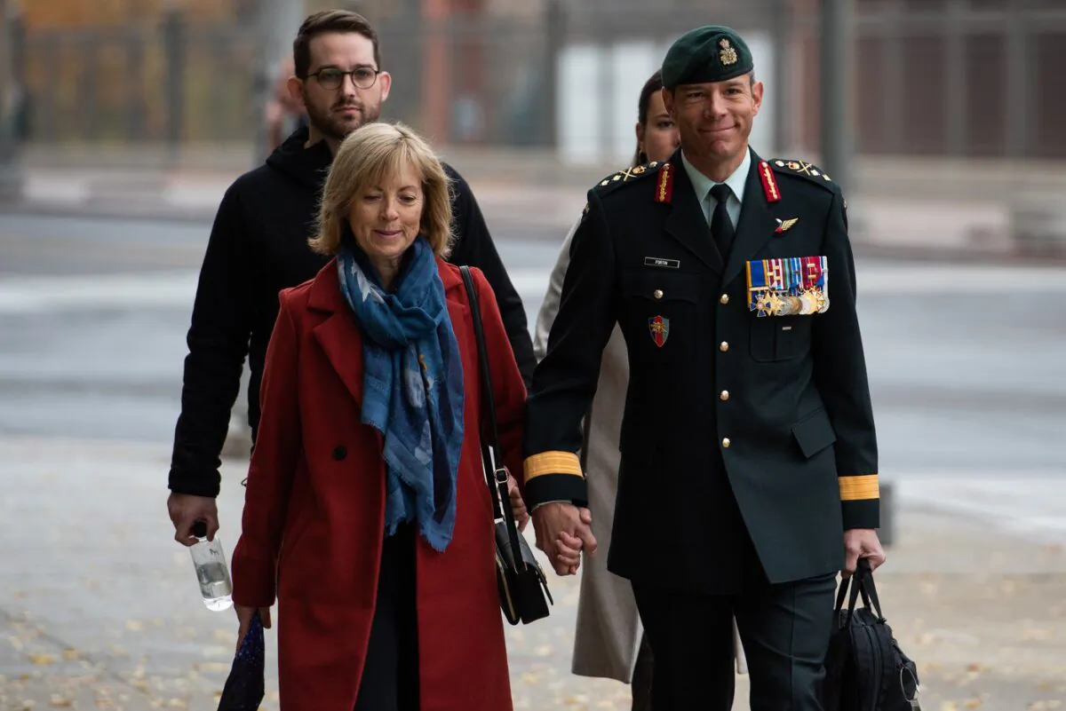 Maj.-Gen. Dany Fortin, right, arrives with his wife Madeleine Collin at a Gatineau, Que. courthouse on Oct. 25, 2022. (The Canadian Press/Spencer Colby)
